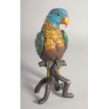 A LARGE COLD PAINTED BRONZE PARROT on a branch. 11ins high.