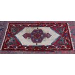 A PERSIAN RUG, pale cream ground central panel with geometric decoration. 6'3" x 3'2"