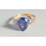 A SILVER GOLD-PLATED, PEAR SHAPED, FAUX TANZANITE AND CUBIC ZIRCONIA RING.