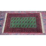 A MODERN BOKHARA RUG, bright green ground with three rows of nine gulls. 5'2" x 3'4"