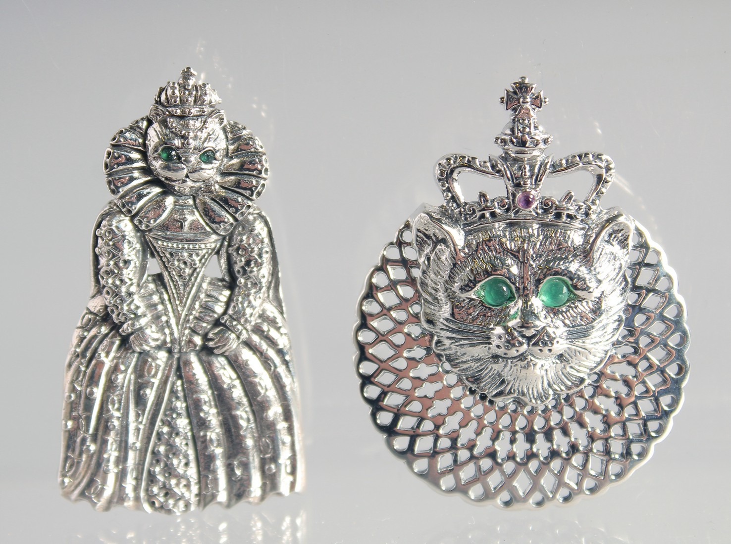 TWO SILVER ROYAL QUEEN CAT BROOCHES AND PENDANT. (3)