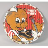 A NOVELTY CIRCULAR ENAMEL SIGN "Piggly Wiggly" 12ins diameter