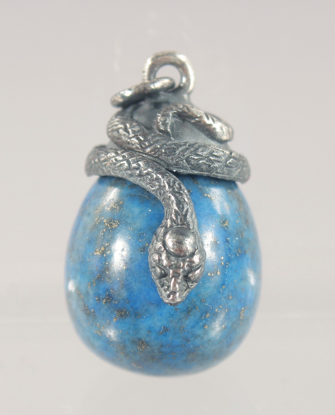 A SILVER MOUNTED LAPIS EGG SHAPED PENDANT. 3cm high