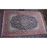 A GOOD PERSIAN CARPET, rust ground with stylised floral decoration. 10'2" x 6'8"
