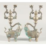 A PAIR OF METAL ELEPHANT FORM CANDLESTICKS, 31cm high.