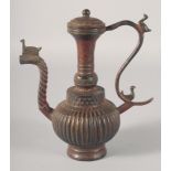AN INDIAN BRONZE LIDDED EWER, the handle and spout with birds, 23.5cm high.