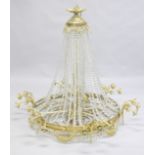 A LARGE ORMOLU AND CRYSTAL CIRCULAR CHANDELIER with four rows of prism drops, six triple pairs of