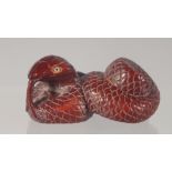 A CARVED WOOD NETSUKE modelled as a snake. 5.5cm long.