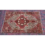 A PERSIAN DESIGN RUG, cream ground with stylised pink floral decoration. 4'11" x 3'3"