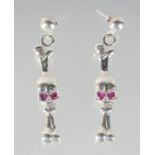 A PAIR OF SILVER SKULL AND BONE DROP EARRINGS.