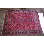 A LARGE PERSIAN CARPET, red ground with floral decoration (damage to one corner). 11'10" x 8'8"