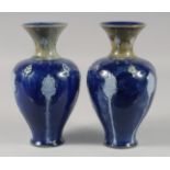 A PAIR OF ROYAL DOULTON STONEWARE BLUE VASES. 8ins high.