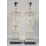 A PAIR OF MOULDED GLASS URN SHAPED LAMPS on marble bases. 23ins high.