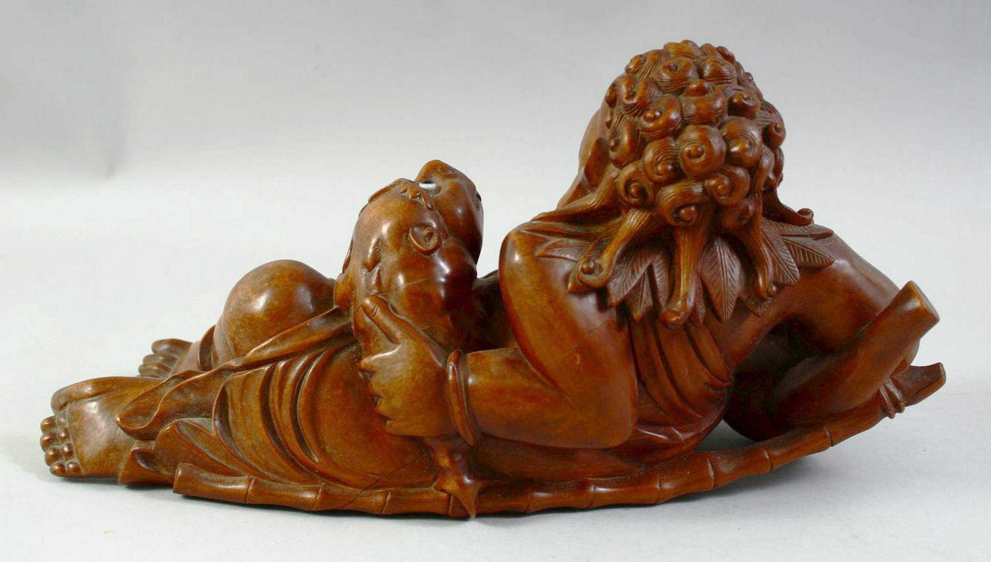 A LARGE CARVED HARDWOOD HOTEI, on a fitted carved hardwood stand, the figure reclining with a - Image 5 of 7