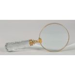 A MAGNIFYING GLASS with cut glass handle.