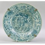 A CHINESE BLUE AND WHITE PORCELAIN DISH, painted with panels figures and objects. 29.5cm diameter.