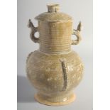 A CHINESE HAN STYLE POTTERY VASE AND COVER, with moulded twin handles, 28.5cm high.