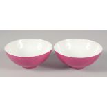 A PAIR OF CHINESE PINK GLAZE PORCELAIN TEACUPS, each with mark to base, 8cm diameter.