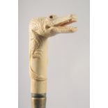 A WALKING STICK WITH CARVED BONE HANDLE as an alligator.