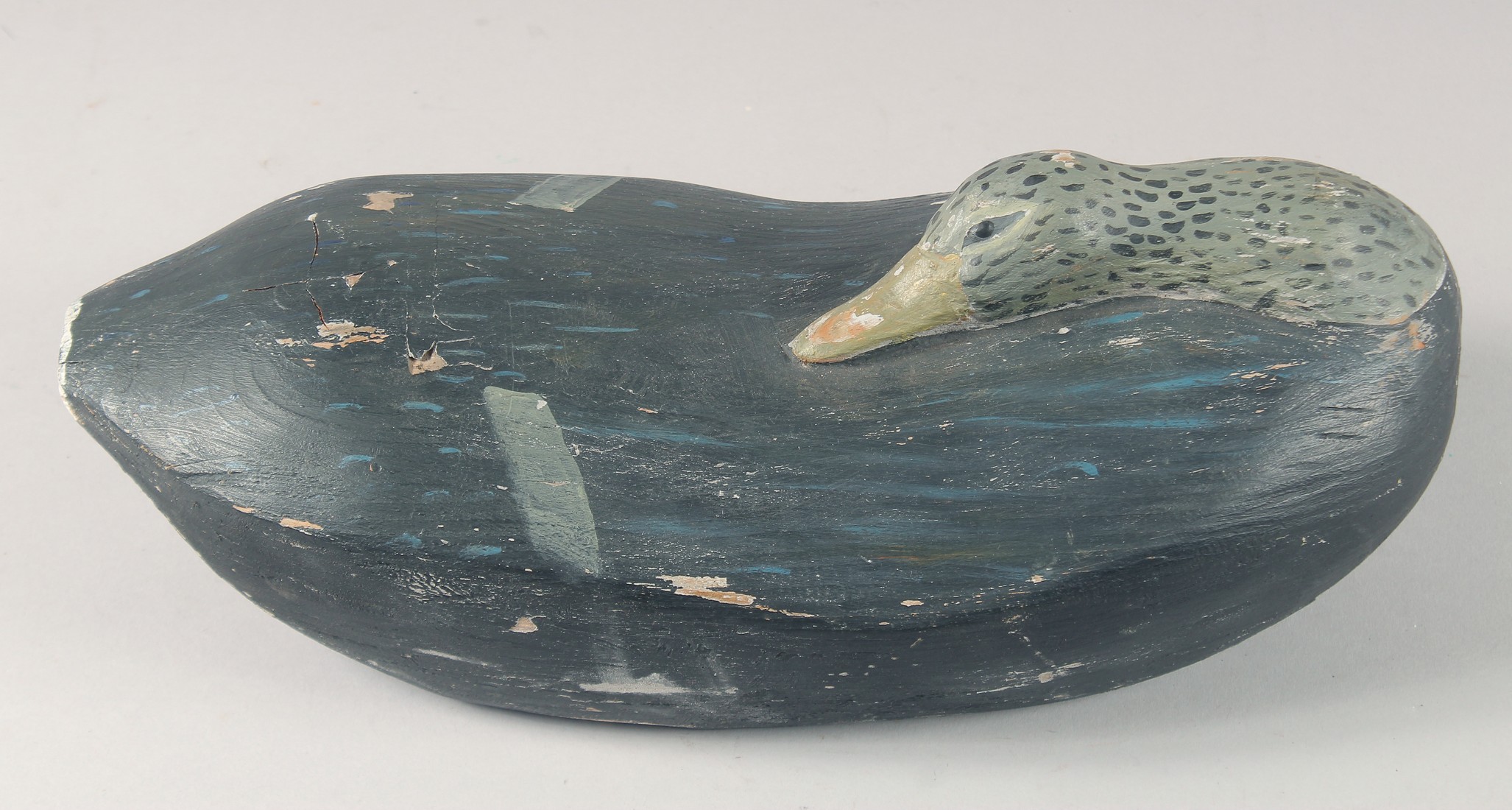 A HEAVY PAINTED DECOY DUCK. 13ins long.