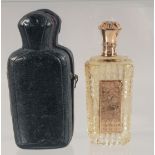 A CUT GLASS SCENT BOTTLE WITH HINGED GOLD TOP, cased. 9cm high