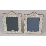 A PAIR OF VICTORIAN STYLE SILVER PHOTOGRAPH FRAMES. 7.75" x 5.75"