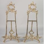 A PAIR OF ORNATE BRASS EASELS 21ins high.