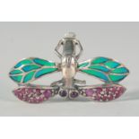 A SILVER RUBY DRAGONFLY RING.