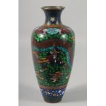 A JAPANESE CLOISONNE VASE decorated with a dragon. 10.5ins high.
