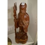 A Chinese carved wood standing figure of a sage.