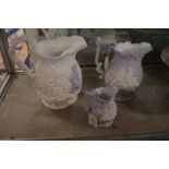 Three relief moulded jugs with lilac tinted decoration.