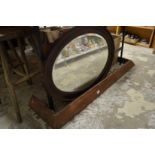 An oval mirror and a copper fender.