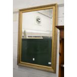 A gilt framed mirror.