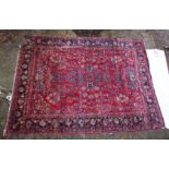 A large Persian carpet, red ground with floral decoration (damage to one corner) 11'10" x 8'8".