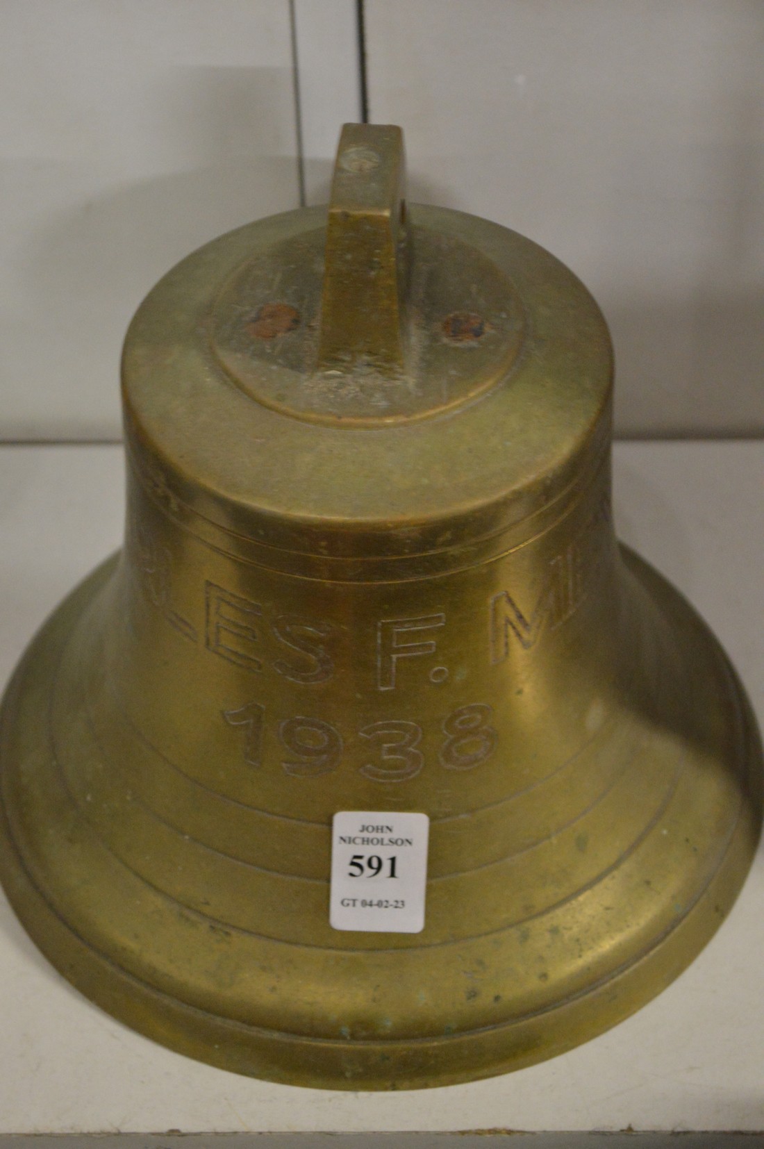 A bronze bell engraved Charles F Meyer 1938.