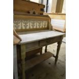 A marble top pine wash stand with tiled splashback.