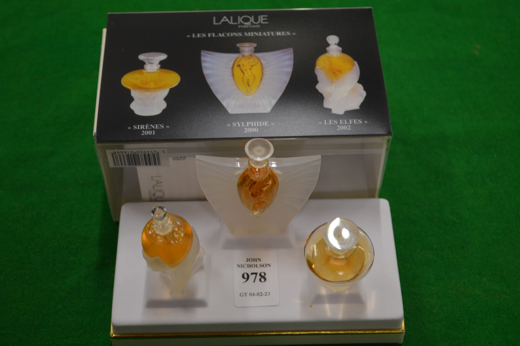 The Lalique miniature glass perfume bottle collection with original packaging.