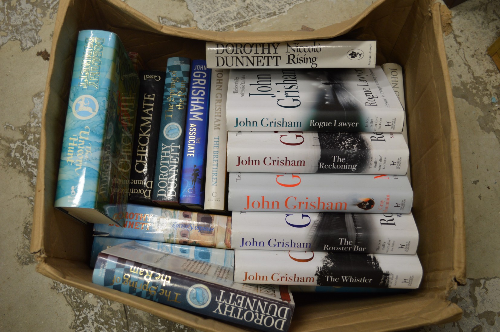 A box of first editions to include John Grisham etc.