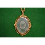 A rock crystal pendant with gilt metal frame and necklace.