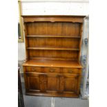 A good oak dresser with delft rack, three drawers and three cupboard doors.
