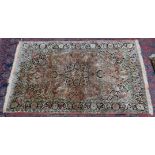 A Persian part silk rug, orange ground with stylised floral decoration 6' x 3'11".