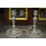 A pair of Herend porcelain candlesticks.