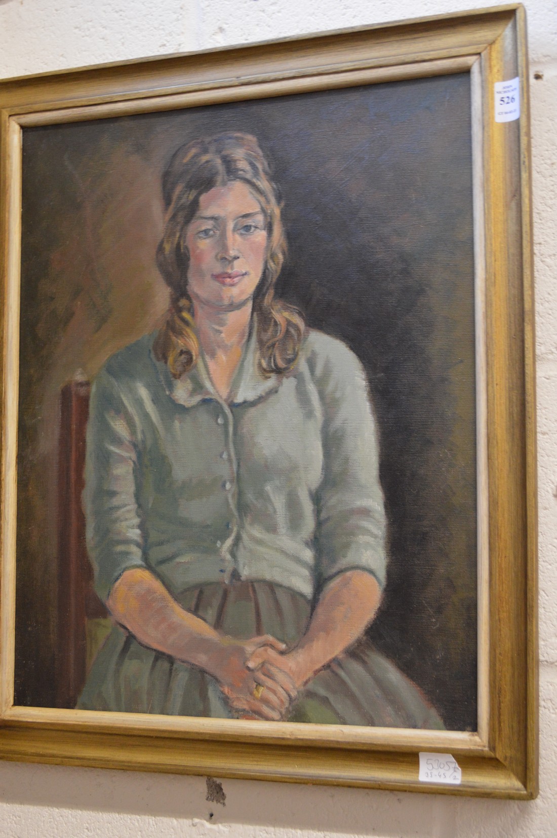 Portrait of a seated young lady wearing a blue cardigan, oil on board.