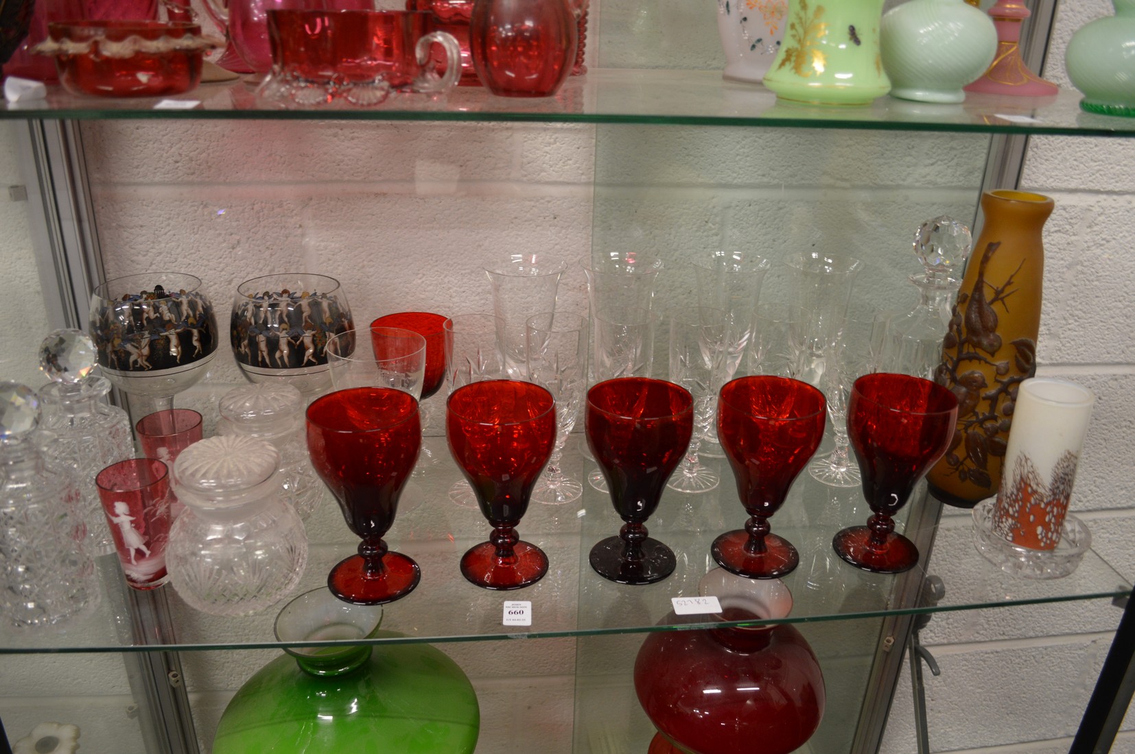 A shelf of glassware to include a pair of decanters, Galle style vase etc.