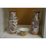 Two Chinese famille rose vases and a famille jaune tea bowl.
