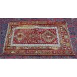 A Kelim rug, beige and red ground with geometric decoration 5'7" x 3'5".