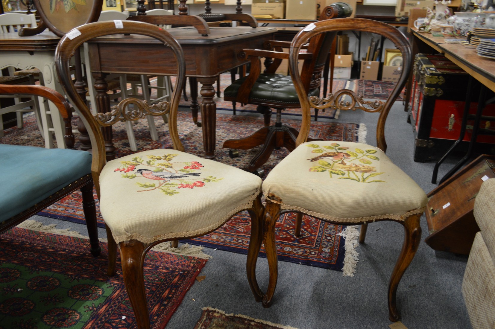 A pair of Victorian rosewood balloon back dining chairs.