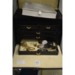 A jewellery box containing watches and a small amount of jewellery.