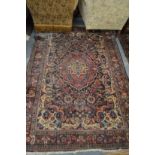 A Persian carpet, green ground with floral decoration 6'10" x 4'8" (some damage).