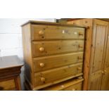 A pine chest of drawers.